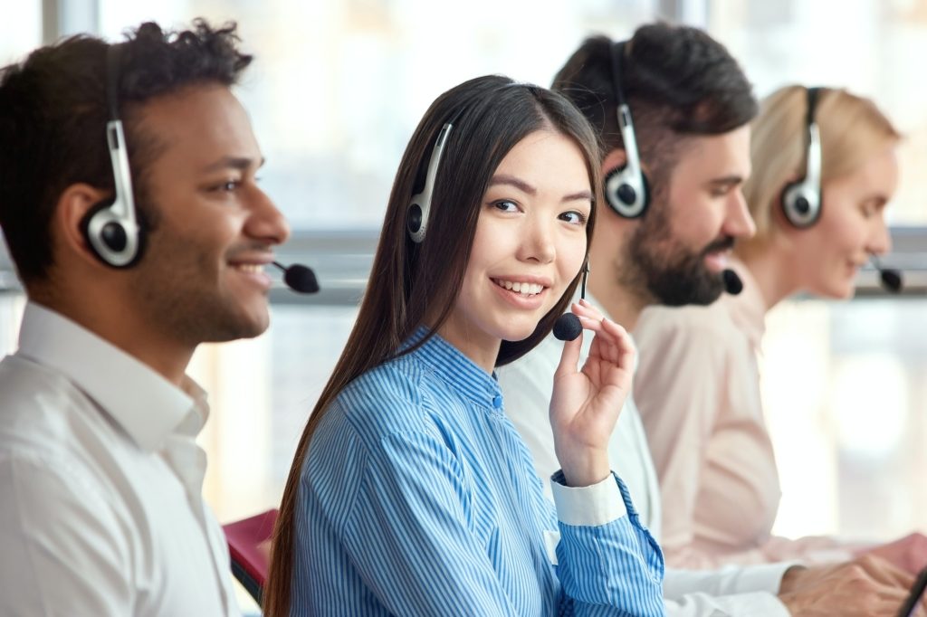 Korean girl in call center with colleagues.